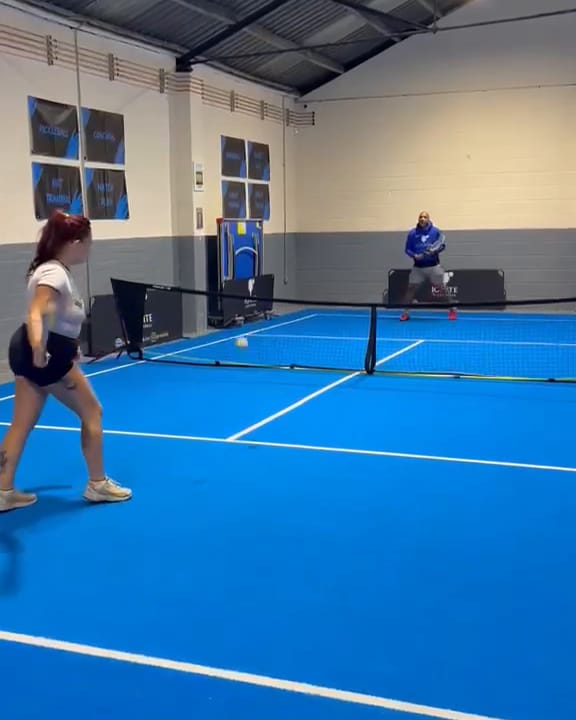A player waiting to return on the blue touch tennis court at Ignite