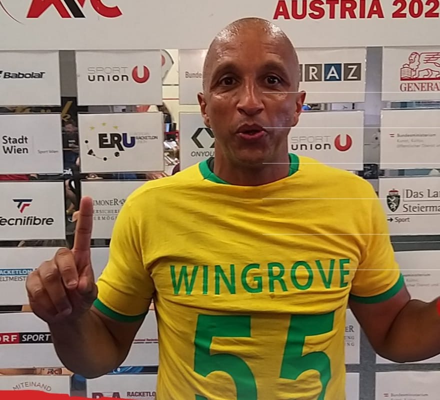 Jermaine Manners at the 2022 Racketlon World Championships in Austria, wearing a yellow shirt with green trim that reads Wingrove 55